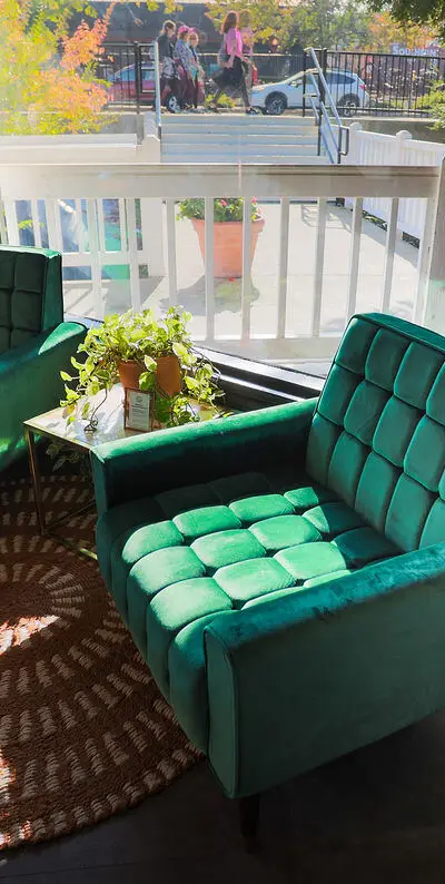 The Nook green armchairs by the window in Folsom, CA